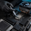 Technician applying thermal paste to a CPU